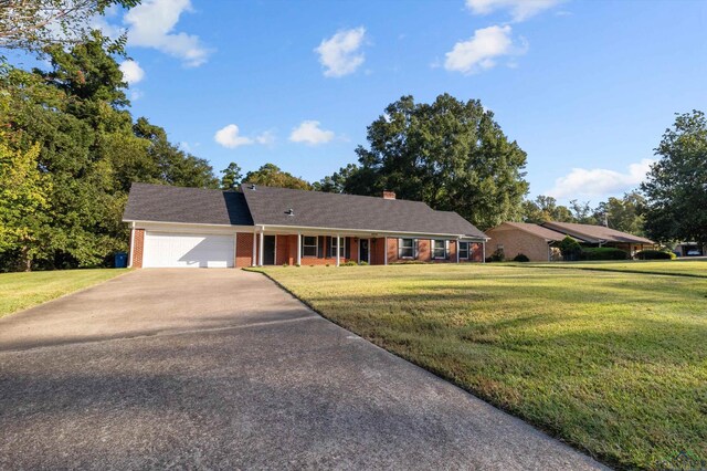 ranch-style house with a garage and a front yard