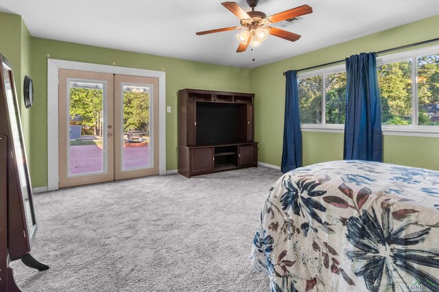 bedroom featuring access to exterior, french doors, multiple windows, and ceiling fan