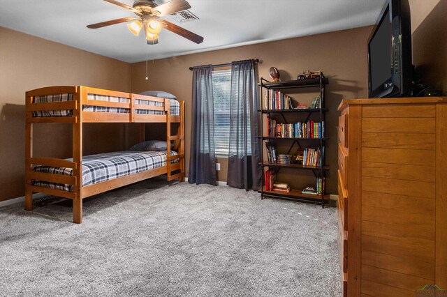 bedroom featuring ceiling fan and carpet