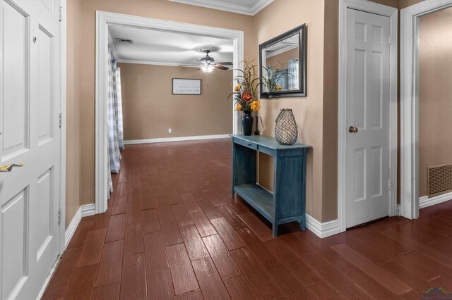 hall with dark hardwood / wood-style floors and crown molding