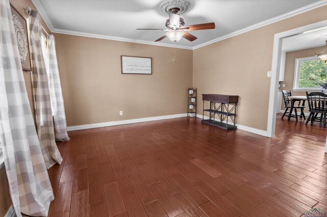 spare room with dark hardwood / wood-style floors, ceiling fan, and crown molding