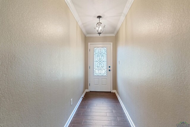 1130 Oakwood St, Carthage, TX 75633 - doorway with dark wood finished floors, baseboards, a chandelier, ornamental molding, and a textured wall