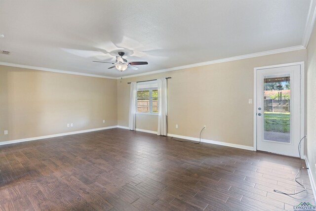 1130 Oakwood St, Carthage, TX 75633 - unfurnished room with ceiling fan, dark wood-style flooring, crown molding, and baseboards