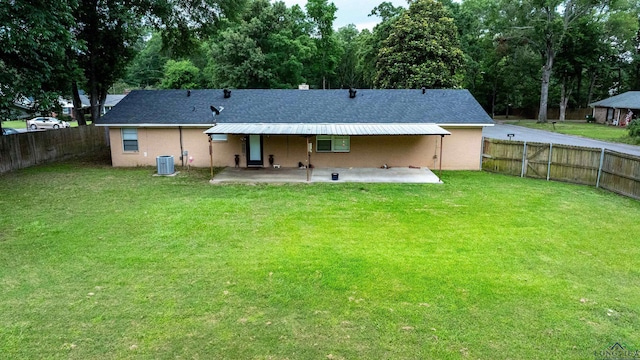 1130 Oakwood St, Carthage, TX 75633 - rear view of house featuring a patio, central air condition unit, and a shingled roof