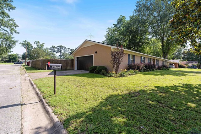 1130 Oakwood St, Carthage, TX 75633 - view of property exterior featuring driveway and stucco siding