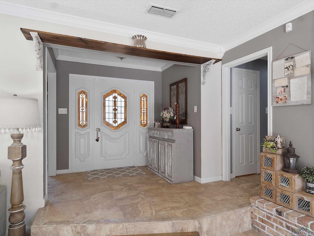 entrance foyer with a textured ceiling and ornamental molding