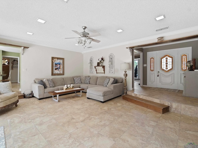 living room with a textured ceiling, ceiling fan, and crown molding