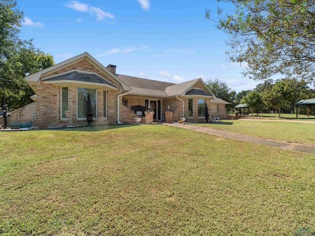 view of front of house with a gazebo and a front yard