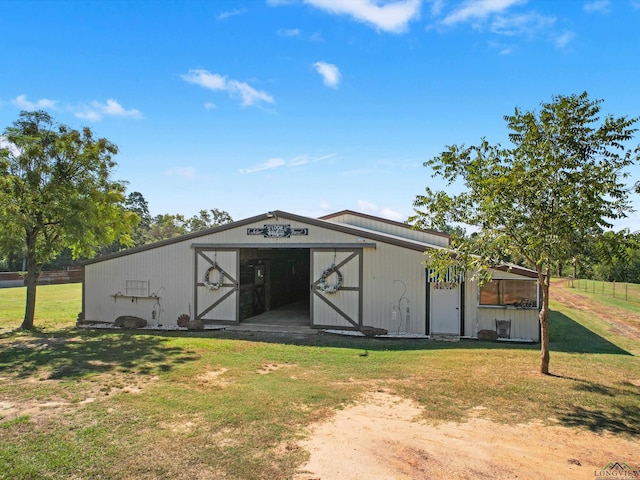 view of outbuilding featuring a yard