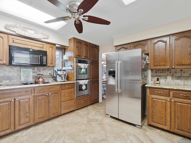 kitchen with ceiling fan, tasteful backsplash, crown molding, light tile patterned flooring, and black appliances