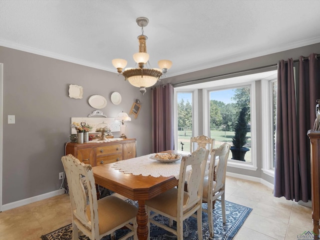 tiled dining area featuring ornamental molding, a textured ceiling, and an inviting chandelier