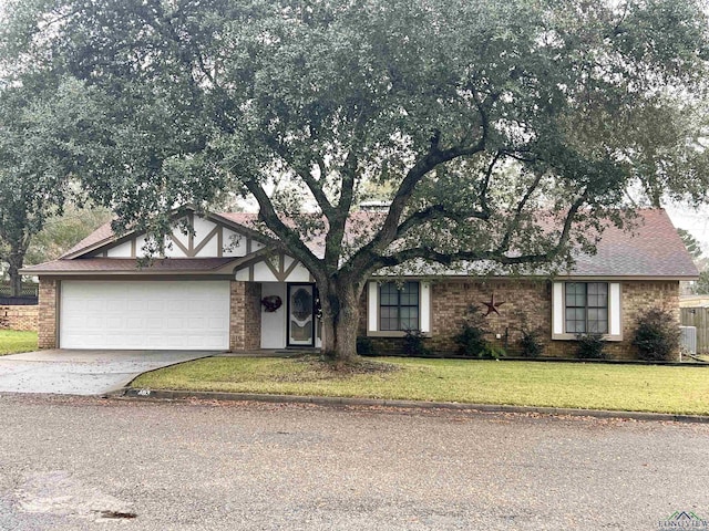 view of front of property with a garage and a front lawn