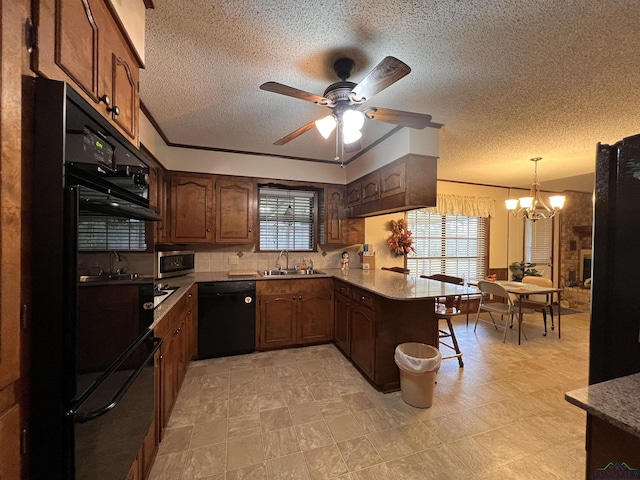 kitchen featuring dishwasher, sink, kitchen peninsula, decorative light fixtures, and ornamental molding