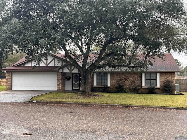 view of front of house featuring a front yard and a garage