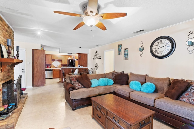 living room with ceiling fan, a fireplace, visible vents, and crown molding