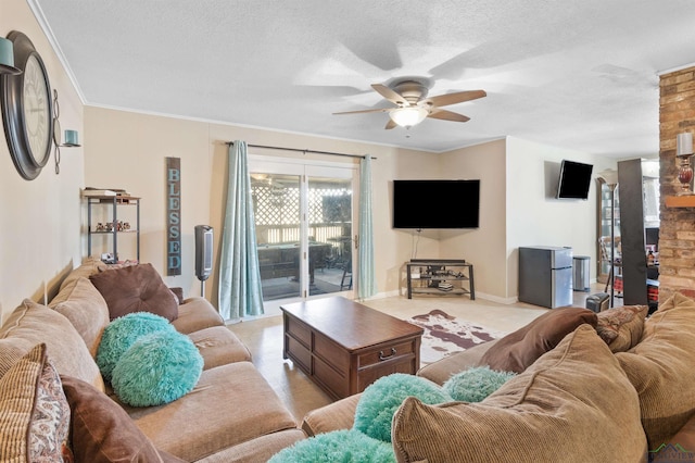 living room with light colored carpet, ornamental molding, a ceiling fan, a textured ceiling, and baseboards