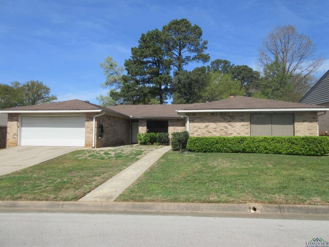 847-849 Montreal Dr, Longview, TX 75601 - view of front facade with a garage, concrete driveway, a front yard, brick siding, and roof with shingles