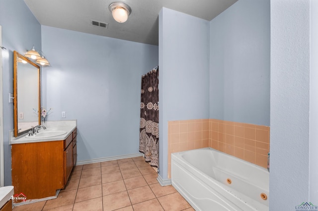 bathroom with tile patterned floors, vanity, and a bath