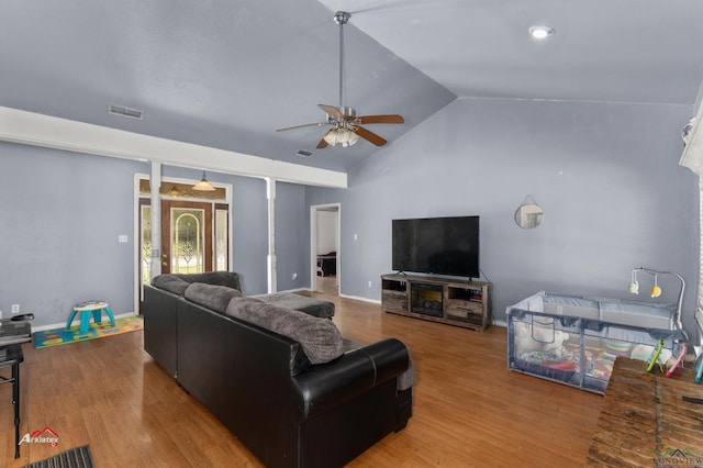 living room with wood-type flooring, ceiling fan, and lofted ceiling