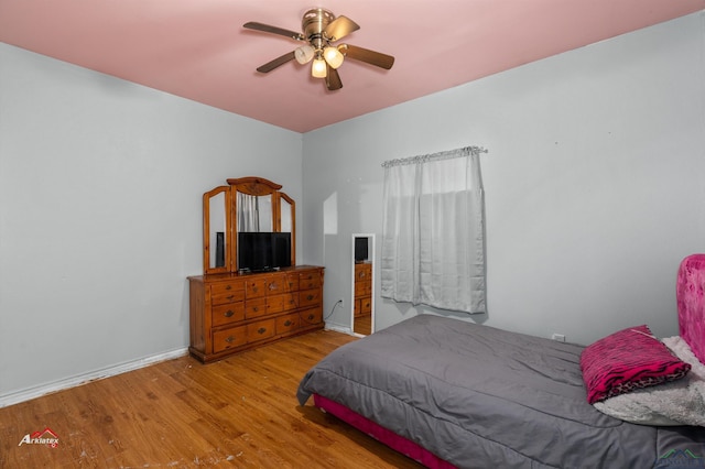 bedroom with ceiling fan and light hardwood / wood-style floors