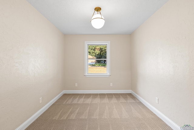 unfurnished room with carpet floors and a textured ceiling