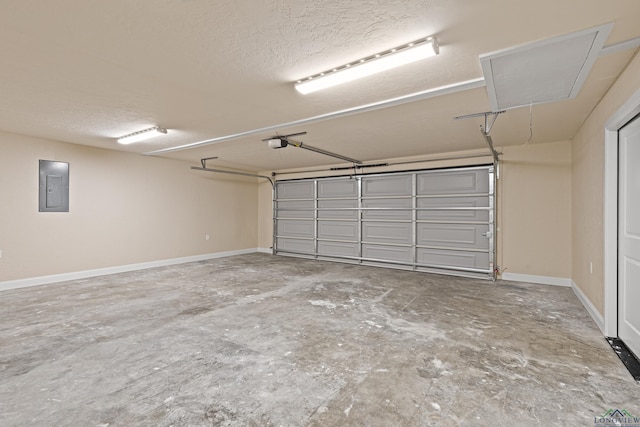 garage with a garage door opener and electric panel