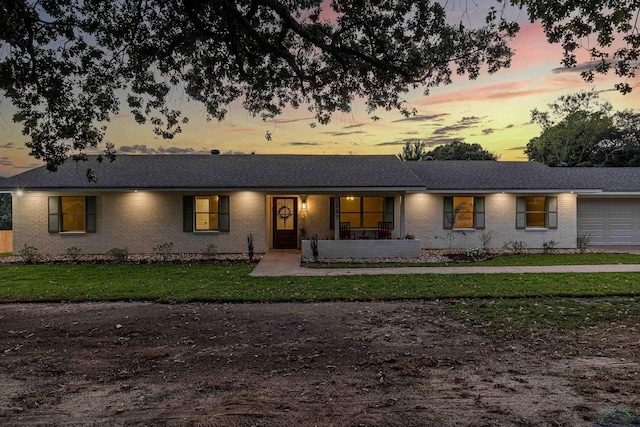 ranch-style home with a lawn and a garage