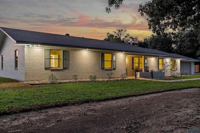 ranch-style home with a lawn and a garage