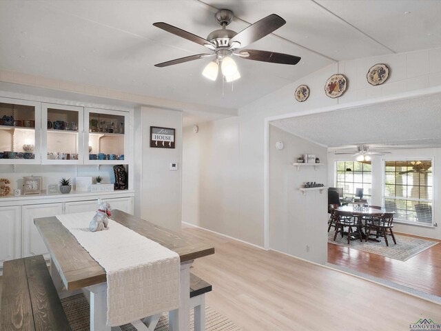 3065 E Lake, Gladewater, TX 75647 - dining area with ceiling fan, vaulted ceiling, and light wood-style flooring