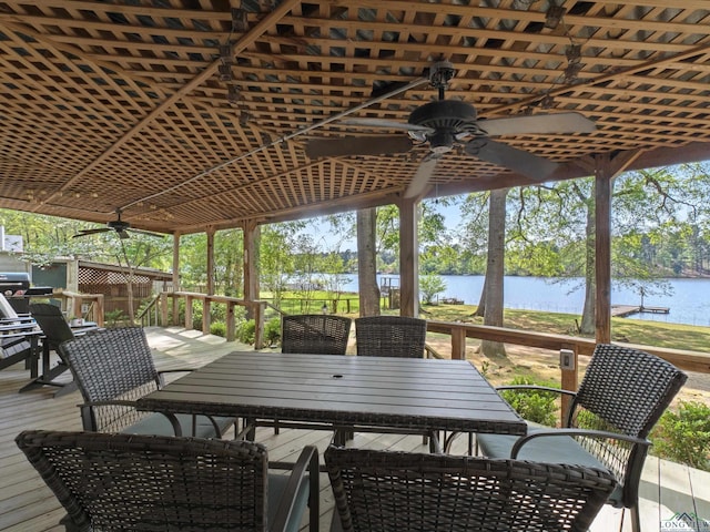 3065 E Lake, Gladewater, TX 75647 - deck with outdoor dining area, ceiling fan, and a water view