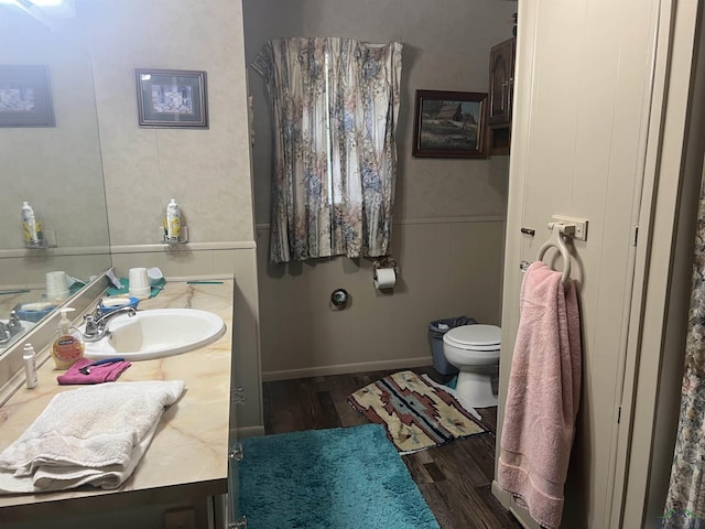 bathroom featuring hardwood / wood-style floors, vanity, and toilet