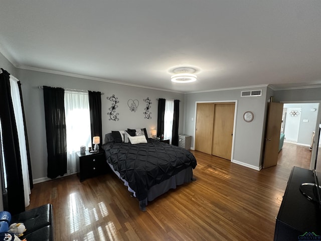 bedroom with dark wood-type flooring and ornamental molding