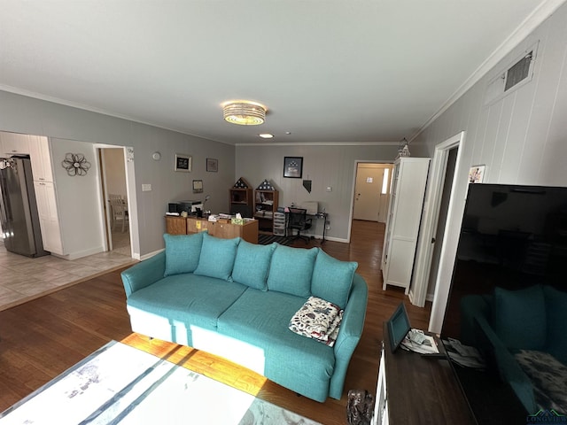 living room featuring hardwood / wood-style flooring and ornamental molding