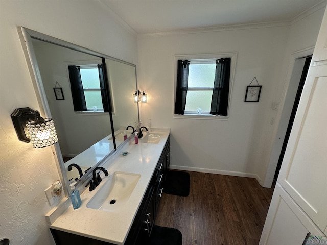 bathroom with hardwood / wood-style flooring, crown molding, plenty of natural light, and vanity