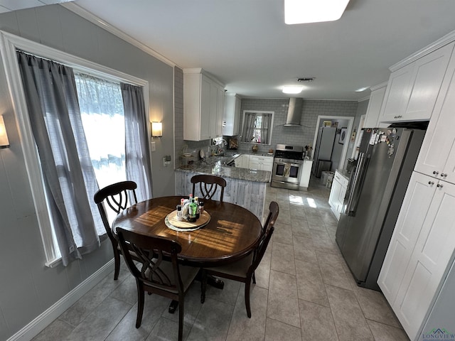 dining area with ornamental molding, plenty of natural light, sink, and light tile patterned floors