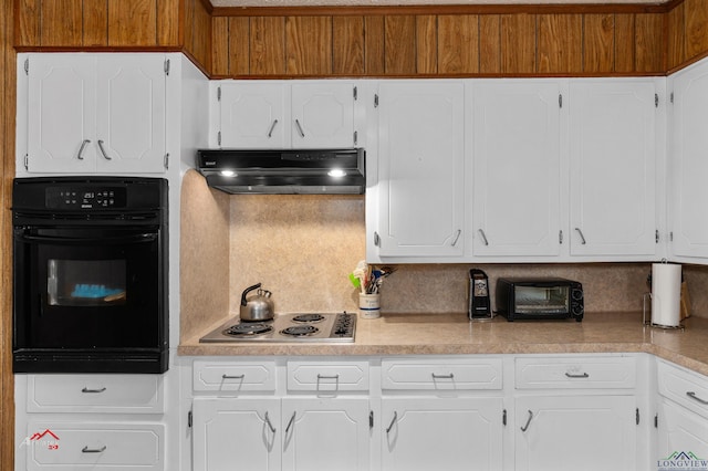 kitchen with white cabinetry, oven, cooktop, and tasteful backsplash