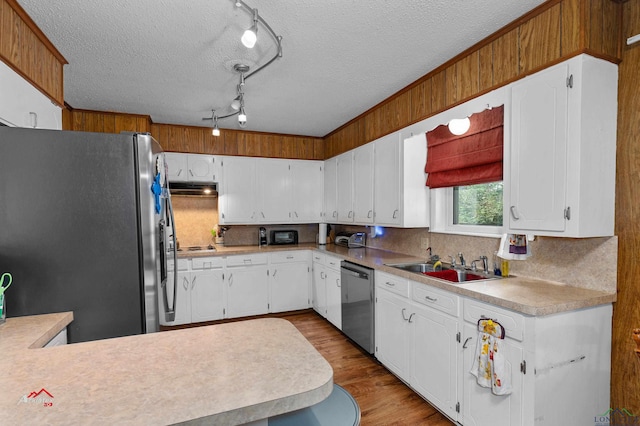 kitchen featuring stainless steel appliances, white cabinetry, sink, and a textured ceiling