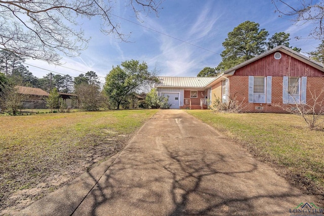 view of front of home with a garage and a front lawn