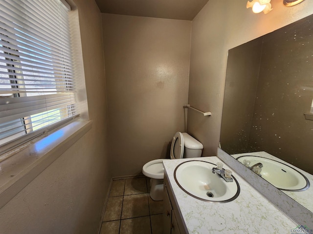 half bath featuring vanity, toilet, and tile patterned floors