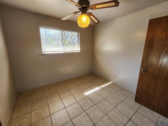 spare room featuring light tile patterned floors and a ceiling fan