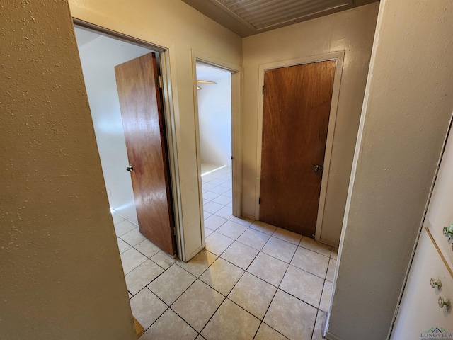 hall with light tile patterned floors