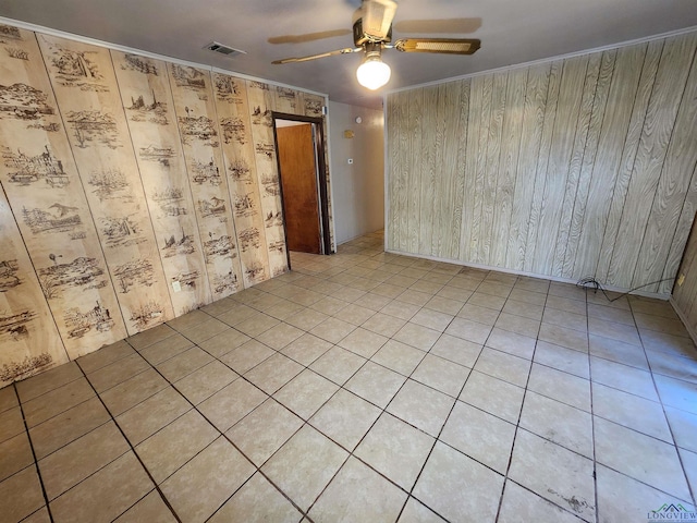 unfurnished room featuring ceiling fan, visible vents, and ornamental molding