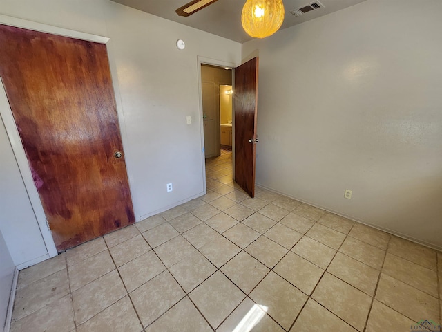 unfurnished bedroom with visible vents and light tile patterned flooring