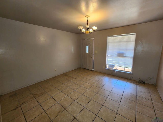 entryway featuring a chandelier and light tile patterned floors