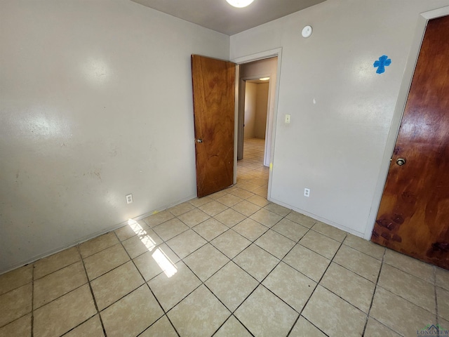 spare room featuring light tile patterned floors