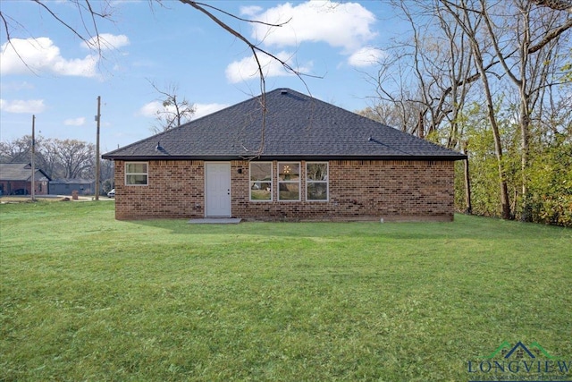 back of property featuring a lawn