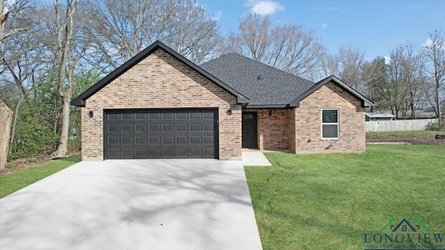 view of front of house featuring a front lawn and a garage