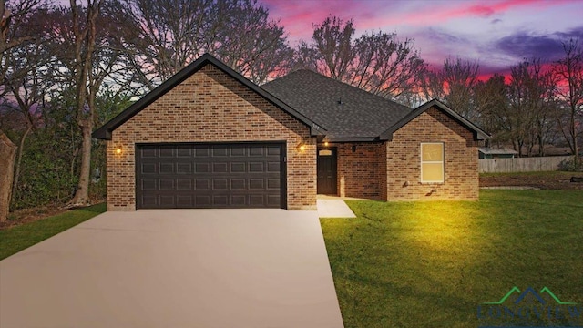 view of front of house with a lawn and a garage