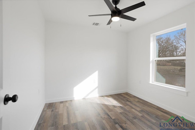 unfurnished room with ceiling fan and dark hardwood / wood-style flooring