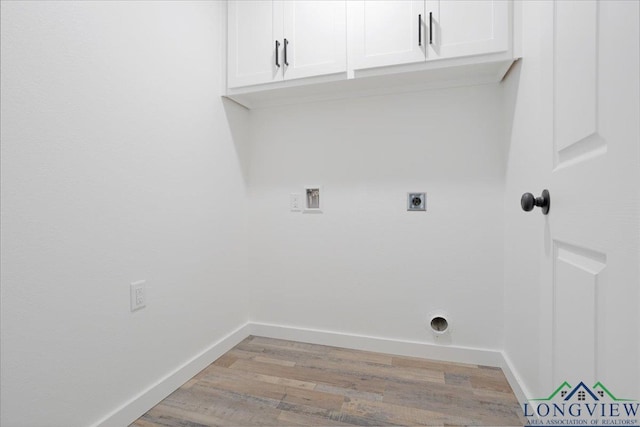 clothes washing area featuring cabinets, light hardwood / wood-style flooring, hookup for an electric dryer, and hookup for a washing machine